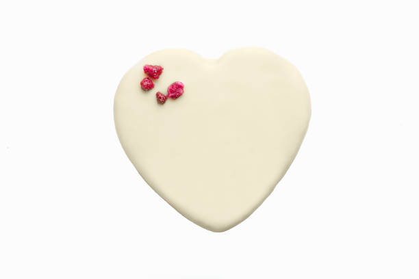 istock white chocolate bonbon with heart shape on white background 1176126919