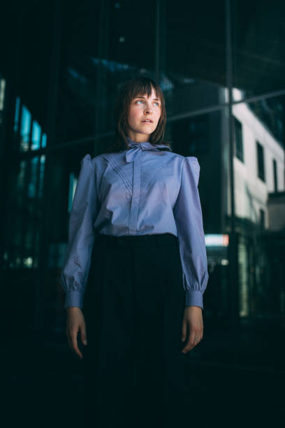 istock Woman Looking Away While Standing Against Wall 1176132353