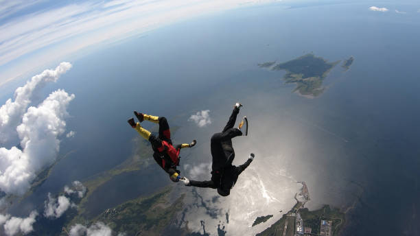 istock Skydivers fall through clear skies, in aerial flight 1176132533