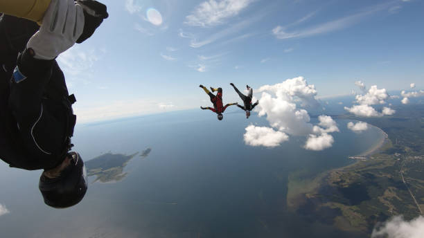 istock Skydivers fall through clear skies, in aerial flight 1176132537