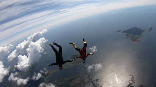 istock Skydivers fall through clear skies, in aerial flight 1176132546