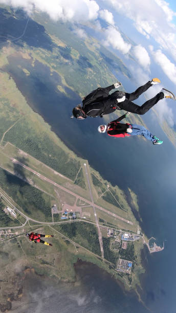 istock Skydivers fall through clear skies, in aerial flight 1176132941