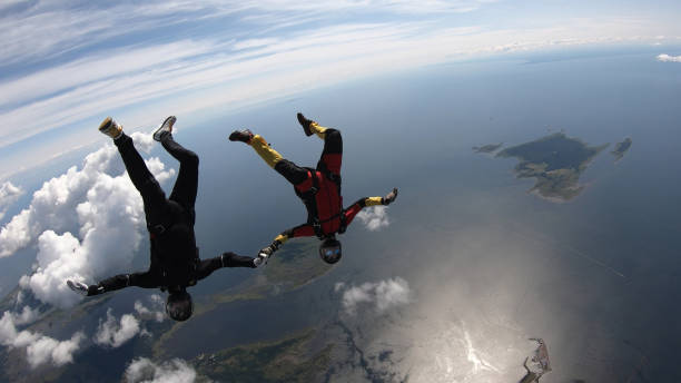 istock Skydivers fall through clear skies, in aerial flight 1176133017