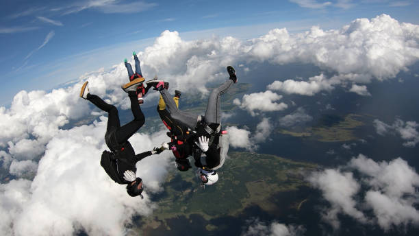 istock Skydivers fall through clear skies, in aerial flight 1176133044