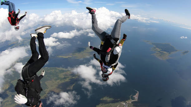 istock Skydivers fall through clear skies, in aerial flight 1176133106