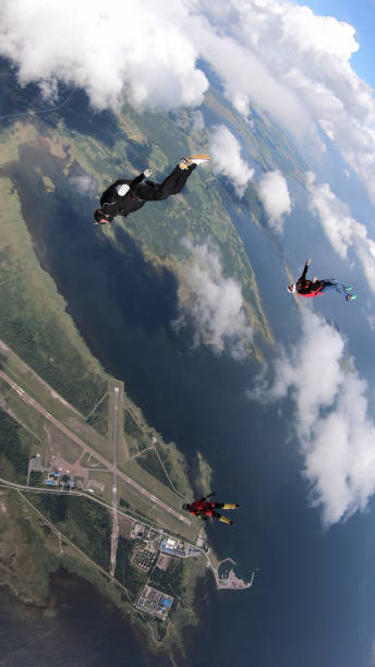 istock Skydivers fall through clear skies, in aerial flight 1176133202
