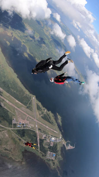 istock Skydivers fall through clear skies, in aerial flight 1176133809