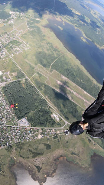 istock Skydivers fall through clear skies, in aerial flight 1176133953
