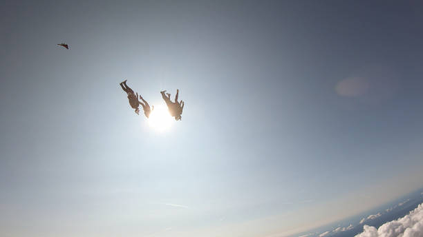 istock Skydivers fall through clear skies, in aerial flight 1176134094