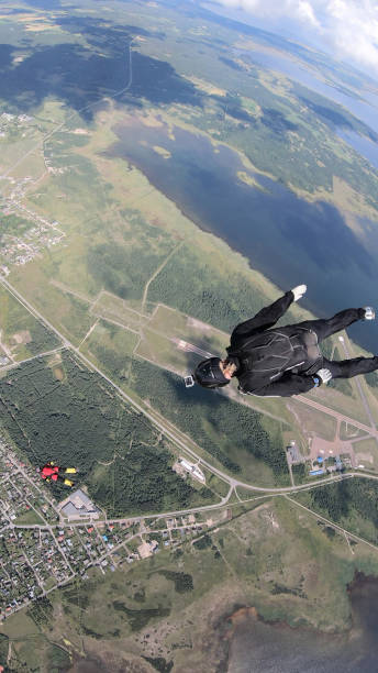 istock Skydivers fall through clear skies, in aerial flight 1176134168
