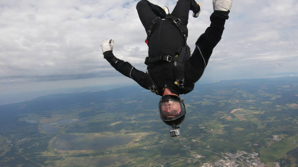 istock Skydiver falls through clear skies, aerial flight 1176134223