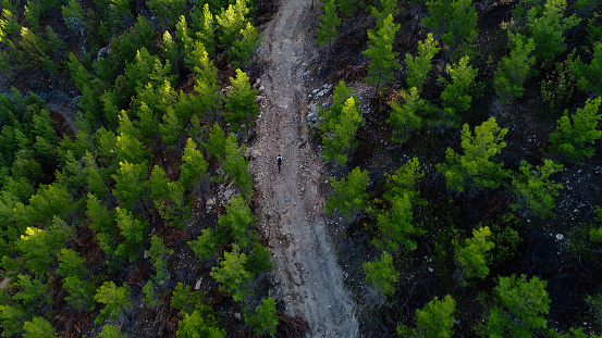 Mountain Biker Riding on a dirt road aerial view