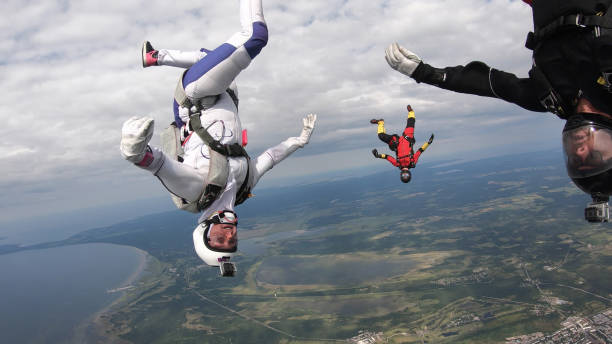 istock Skydivers fall through clear skies, in aerial flight 1176134301