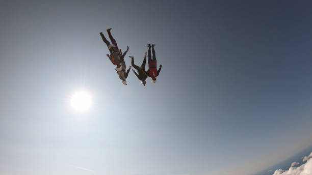 istock Skydivers fall through clear skies, in aerial flight 1176134406