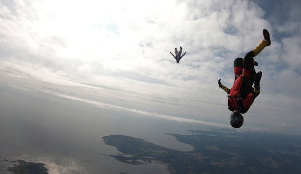 istock Skydivers fall through clear skies, in aerial flight 1176134409