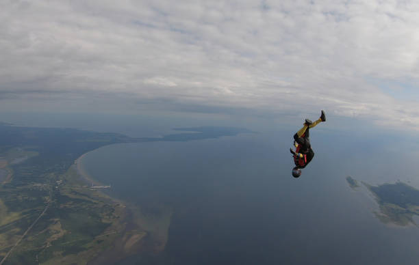 istock Skydiver falls through clear skies, aerial flight 1176134423