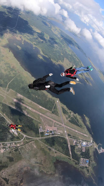 istock Skydivers fall through clear skies, in aerial flight 1176134569