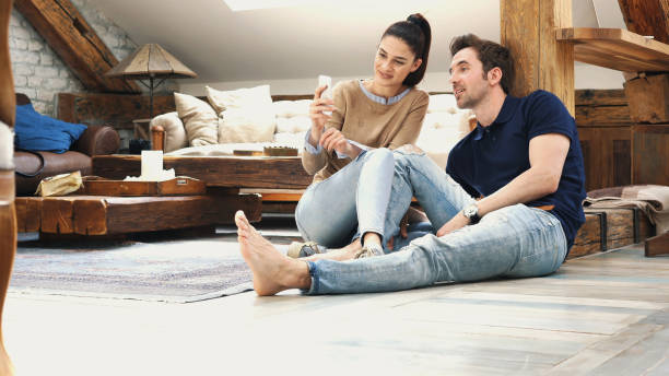 istock happy couple talking to each other at home 1176135462