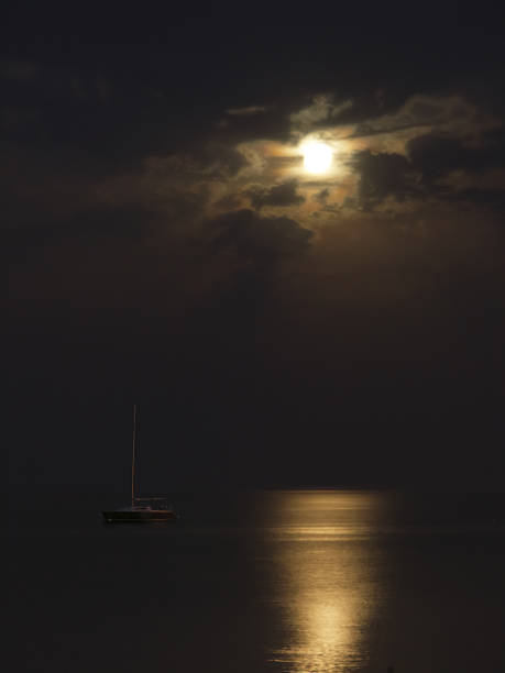 istock Lonely yacht with lowered sails is illuminated by the moon 1176135775