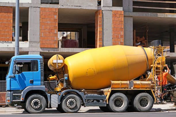 istock Cement mixer truck next to a construction site 1176136909