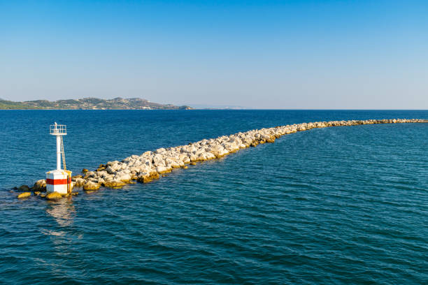 istock Breakwater rocks with small lighthouse at the end 1176138042