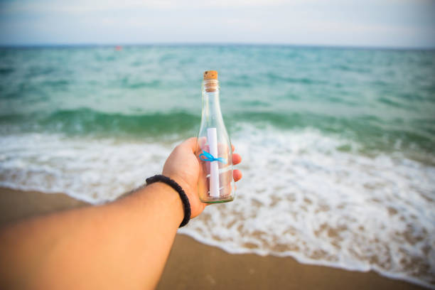 istock Message in a glass bottle in hand 1176138581