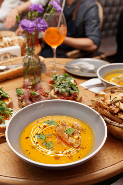 istock Pumpkin soup and another food on table 1176140013