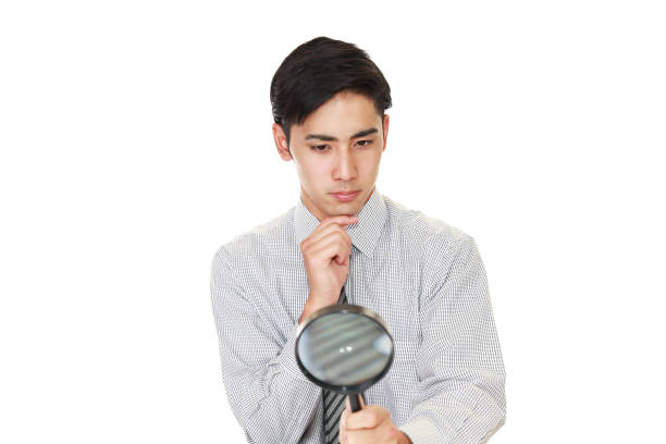 istock Businessman holding a magnifying glass 1176143344