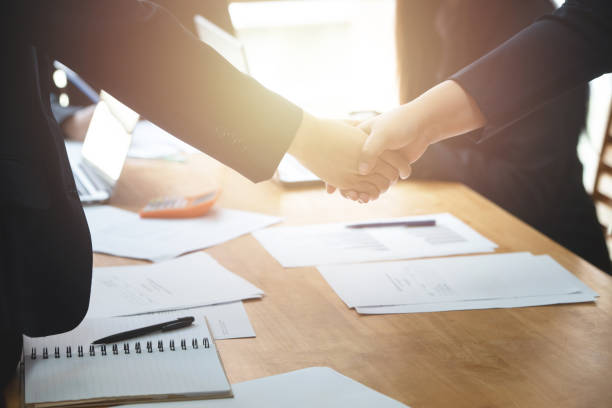 istock Young business people shaking hands in the office. 1176150016