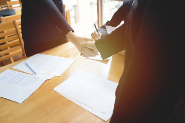 istock Young business people shaking hands in the office. 1176150307