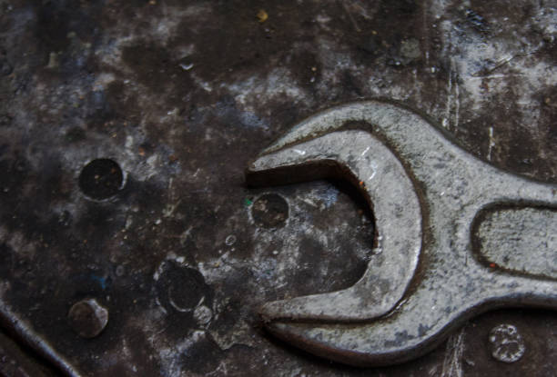 istock Wrench on black/grey textured background. 1176151152