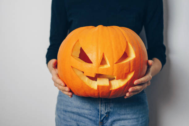 Woman holding a Halloween pumpkin