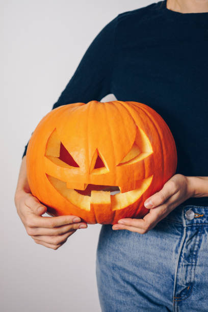 istock Woman holding a Halloween pumpkin 1176151524