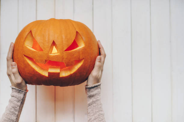istock Woman holding a Halloween pumpkin 1176151533