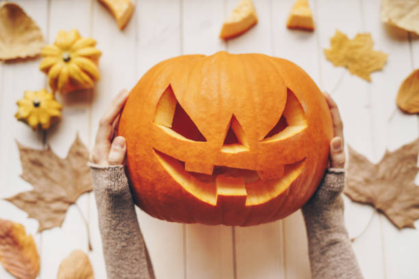 istock Woman holding a Halloween pumpkin 1176151539