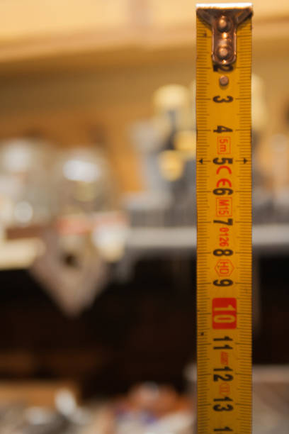 istock Yellow Measuring Tape on the black background. 1176152742