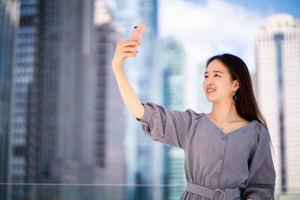 istock Young Asian woman taking a selfie 1176152826