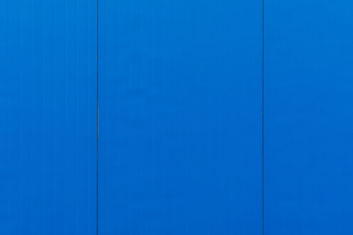 Close-up of electric blue vertical tiles on smooth surface, desktop or exterior design.