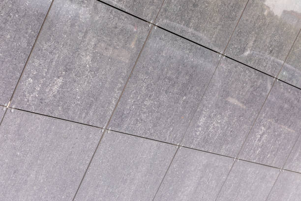 istock Gray dirty concrete panels on wall surface, diagonal view. 1176153805