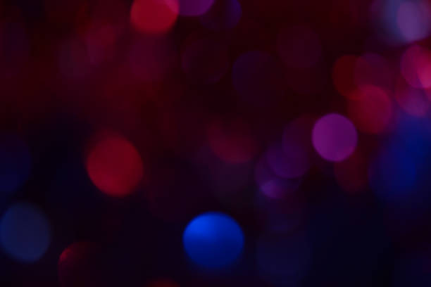 istock Bokeh. Holiday background. Christmas lights. Glitter. Defocused sparkles. New Year backdrop. Festive wallpaper. Blinks. Carnival. Bokeh retro style photo. Violet. Red. Blue. 1176154682