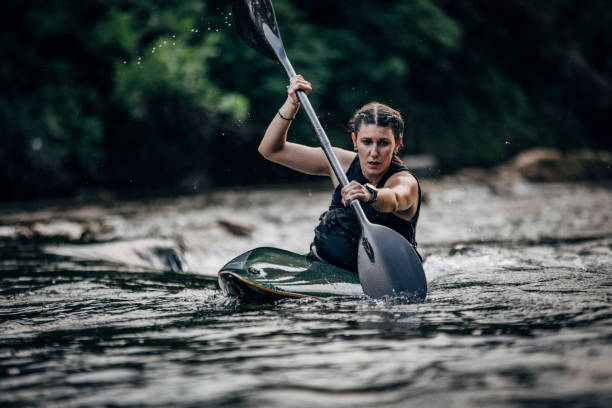istock Beautiful young woman kayaking 1176155422