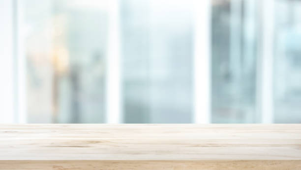 istock Selective focus of wood table top on white wall glass background 1176159023