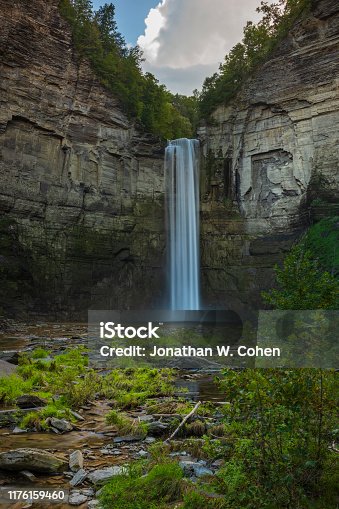 istock Taughannock Falls is a 215-foot (66 m) plunge waterfall, that is the highest single-drop waterfall east of the Rocky Mountains, located about 10 miles north of Ithaca in New York State, USA. 1176159460