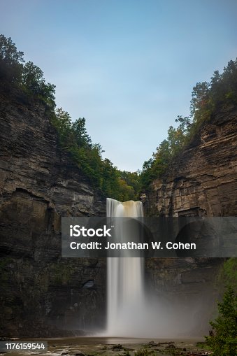 istock Taughannock Falls is a 215-foot (66 m) plunge waterfall, that is the highest single-drop waterfall east of the Rocky Mountains, located about 10 miles north of Ithaca in New York State, USA. 1176159544