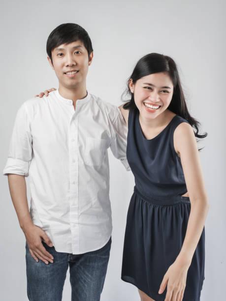 istock Asian couple hugging together with gray background. 1176164409
