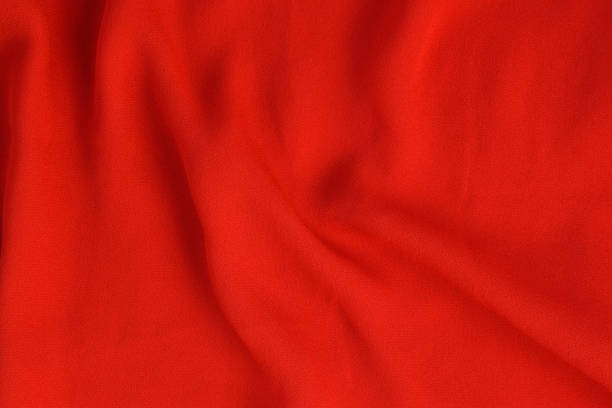 istock Crumpled texture of bright red seamless fabric. 1176169372