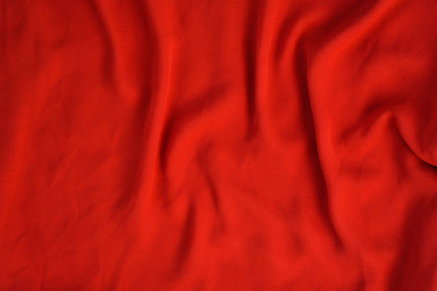 istock Crumpled texture of bright red seamless fabric. 1176169373