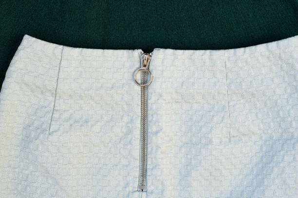istock Silver zipper on pale green textured clothes. Close-up 1176169459