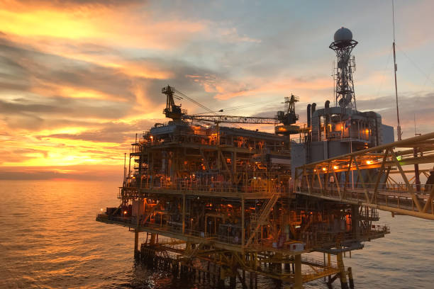 istock Offshore construction platform for exploration and production oil and gas with bridge in evening time for power energy of the world concept. 1176169886
