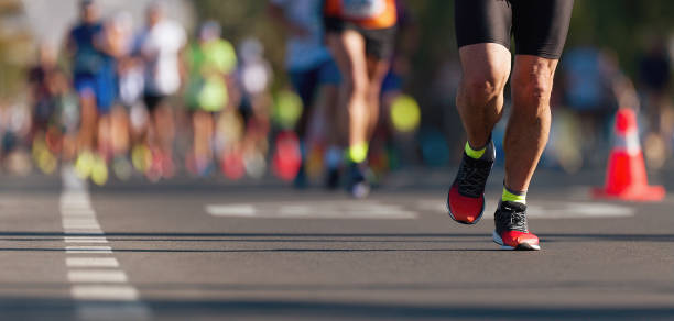 Marathon running race Marathon running race, people feet on city road marathon stock pictures, royalty-free photos & images